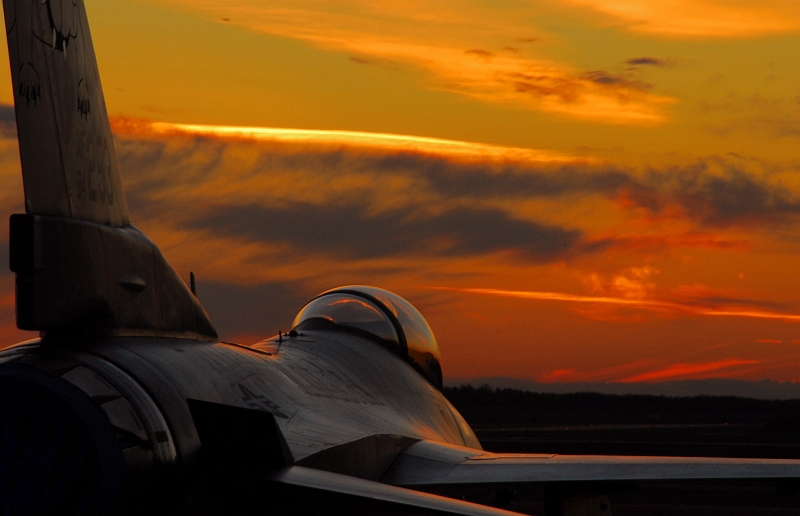 80. Very Beautiful Sunset on October 13, 2007, and a Parked USAF F-16C Fighting Falcon Fighter Jet Assigned to the 148th Fighter Wing, Minnesota Air National Guard at the Air National Guard Base, Duluth, State of Minnesota, USA. Photo Credit: Senior Airman Donald Acton, United States Air Force; Air Force Link - Week in Photos, October 19, 2007 (http://www.af.mil/weekinphotos/071019-03.html and http://www.af.mil/weekinphotos/wipgallery.asp?week=251, 071013-F-5084A-969, 'Minnesota sunset'), United States Air Force (USAF, http://www.af.mil), United States Department of Defense (DoD, http://www.DefenseLink.mil or http://www.dod.gov), Government of the United States of America (USA).