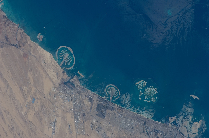 1. Palm Jebel Ali (Left), Palm Jumeirah (Center), and The World (Right), February 1, 2009 at 07:58:12 GMT, Dubai, Al Imarat al Arabiyah al Muttahidah - United Arab Emirates, As Seen From the International Space Station (Expedition 18), Latitude (LAT): 27.3, Longitude (LON): 55.3, Altitude (ALT): 189 Nautical Miles, Sun Azimuth (AZI): 168 degrees, Sun Elevation Angle (ELEV): 45 degrees. Photo Credit: NASA, International Space Station (Expedition Eighteen); ISS018-E-25364, Palm Jebel Ali and Palm Jumeirah (The Palm Islands), The World (World Islands), Dubai, United Arab Emirates; Image Science and Analysis Laboratory, NASA-Johnson Space Center. 'Astronaut Photography of Earth - Display Record.' <http://eol.jsc.nasa.gov/scripts/sseop/photo.pl?mission=ISS018&roll=E&frame=25364>; National Aeronautics and Space Administration (NASA, http://www.nasa.gov), Government of the United States of America (USA).