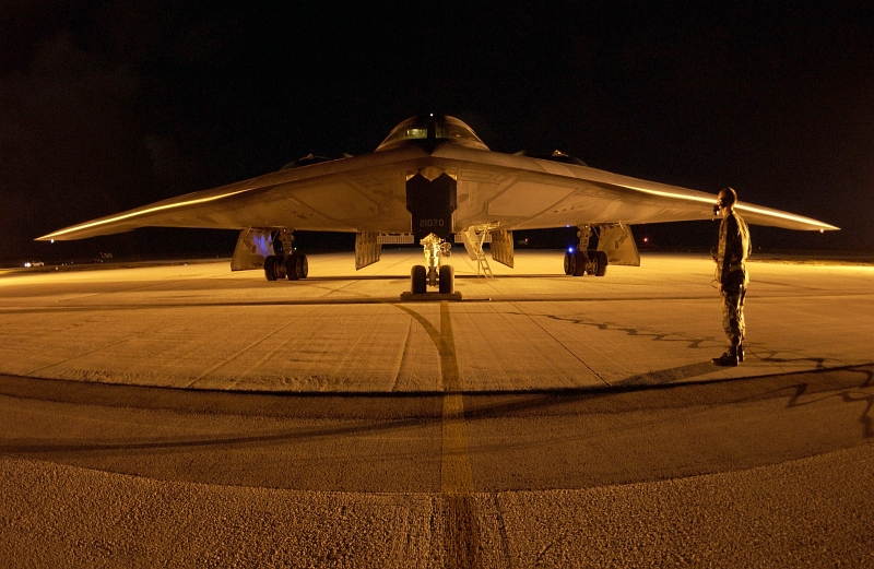 44. A U.S. Air Force Crew Chief Watches and Guards His U.S. Air Force B-2 Spirit Stealth Bomber While Air Crews (Pilots) Switch Shifts at Night, February 5, 2004, Andersen Air Force Base, Territory of Guam, USA. Photo Credit: Staff Sgt. Bennie J. Davis III, United States Air Force; Defense Visual Information (DVI, http://www.DefenseImagery.mil, 040205-F-VY627-233, 040205-F-5040D-233, DFSD0601970, and DF-SD-06-01970) and United States Air Force (USAF, http://www.af.mil), United States Department of Defense (DoD, http://www.DefenseLink.mil or http://www.dod.gov), Government of the United States of America (USA).