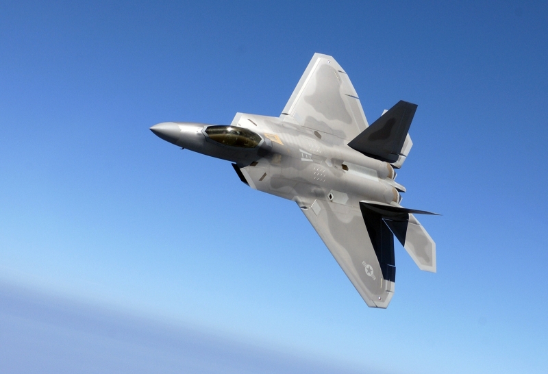 31. Backdropped By A Blue Sky, the U.S. Air Force F-22A Raptor Stealth Fighter Jet Banks During A Training Sortie, August 12, 2005, Langley Air Force Base, Commonwealth of Virginia, USA. Photo Credit: Tech. Sgt. Ben Bloker, Air Force Link - Photos (http://www.af.mil/photos, 050812-F-2295B-147, "Raptor presence"), United States Air Force (USAF, http://www.af.mil), United States Department of Defense (DoD, http://www.DefenseLink.mil or http://www.dod.gov), Government of the United States of America (USA).