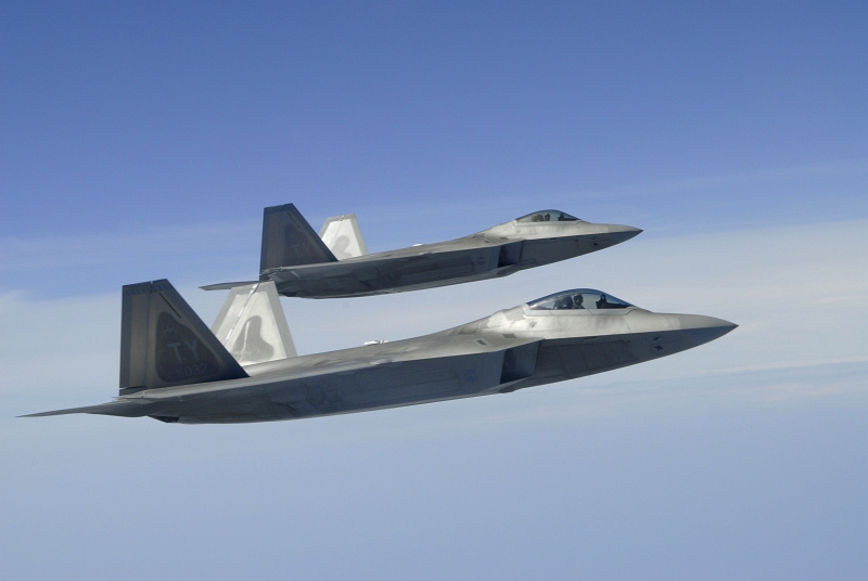 35. Two U.S. Air Force F-22A Raptor Stealth Fighter Jets Fly In the Observation Position As They Prepare For Refueling, April 2, 2007, Over the Gulf Coast, State of Florida, USA. Photo Credit: Senior Master Sgt. Thomas Meneguin, United States Air Force; Defense Visual Information (DVI, http://www.DefenseImagery.mil, 070402-F-WI667-006) and United States Air Force (USAF, http://www.af.mil), United States Department of Defense (DoD, http://www.DefenseLink.mil or http://www.dod.gov), Government of the United States of America (USA).
