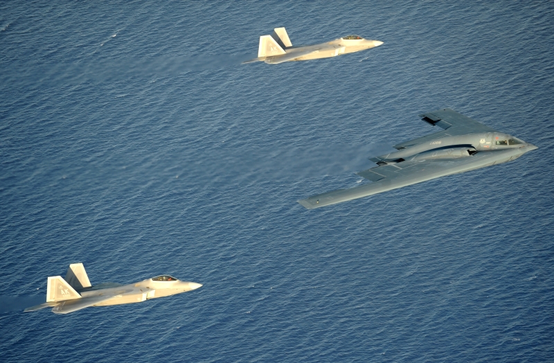 3. The B-2 Spirit Stealth Bomber and Two F-22A Raptor Fighters Flying In Formation Over the Pacific Ocean, April 7, 2009, Territory of Guam, USA. Photo Credit: Master Sgt. Kevin J. Gruenwald, United States Air Force; Defense Visual Information (DVI, http://www.DefenseImagery.mil, 090414-F-6911G-009) and United States Air Force (USAF, http://www.af.mil), United States Department of Defense (DoD, http://www.DefenseLink.mil or http://www.dod.gov), Government of the United States of America (USA).