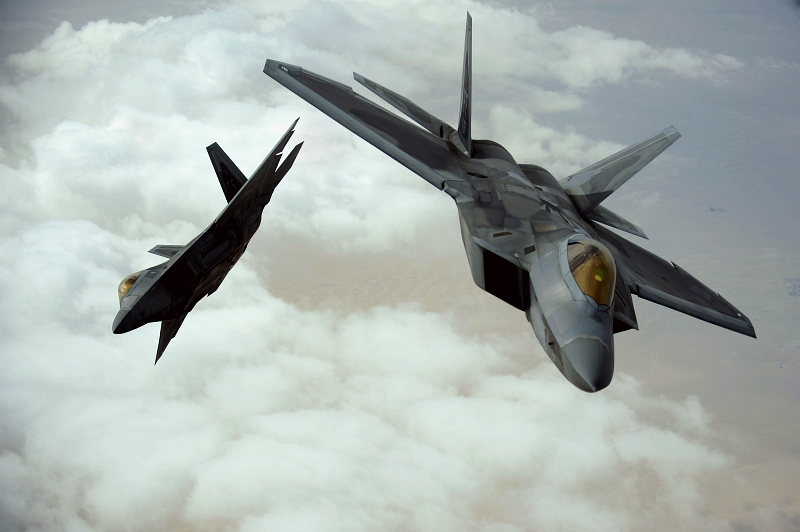 12. Two U.S. Air Force F-22A Raptor Stealth Fighter Jets (Deployed From the 27th Fighter Squadron at Langley Air Force Base in Virginia, USA) Flying Together Over Southwest Asia During A Training Mission at the Iron Falcon Exercise on December 6, 2009, United Arab Emirates - Al Imarat al Arabiyah al Muttahidah. Photo Credit: Staff Sgt. Michael B. Keller, United States Air Force; Defense Visual Information (DVI, http://www.DefenseImagery.mil, 091206-F-8155K-0150) and United States Air Force (USAF, http://www.af.mil), United States Department of Defense (DoD, http://www.DefenseLink.mil or http://www.dod.gov), Government of the United States of America (USA).