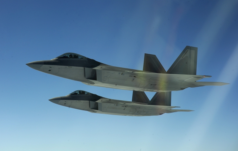 14. Two U.S. Air Force F-22A Raptor Stealth Fighter Jets Flying In Formation, February 17, 2010, Near Territory of Guam, USA. Photo Credit: Staff Sgt. Andy M. Kin, United States Air Force; Defense Visual Information (DVI, http://www.DefenseImagery.mil, 100217-F-4684K-177) and United States Air Force (USAF, http://www.af.mil), United States Department of Defense (DoD, http://www.DefenseLink.mil or http://www.dod.gov), Government of the United States of America (USA).