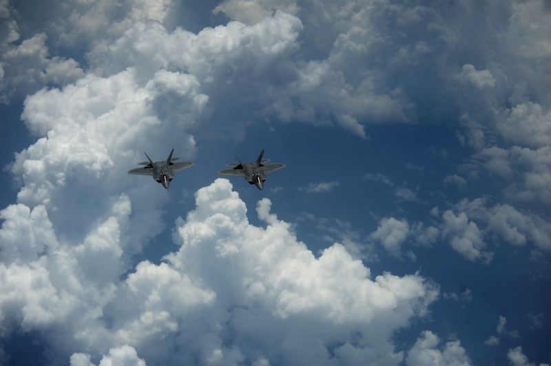 51. Two U.S. Air Force F-22A Raptor Stealth Fighter Jets Fly Over the Clouds Off the East Coast of United States of America, May 10, 2012. Photo Credit: MSgt. Jeremy Lock, United States Air Force; Defense Visual Information (DVI, http://www.DefenseImagery.mil, 120510-F-JQ435-052) and United States Air Force (USAF, http://www.af.mil), United States Department of Defense (DoD, http://www.DefenseLink.mil or http://www.dod.gov), Government of the United States of America (USA).