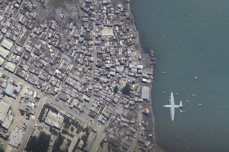 25. A C-130 Hercules Aircraft Makes A Final Approach Into Toussaint Louverture International Airport (Aeroport International Toussaint Louverture), January 16, 2010, Port-au-Prince, Republique d'Haiti (Repiblik d' Ayiti) - Republic of Haiti, As Seen From A U.S. Air Force OC-135B Open Skies Observation Aircraft. Photo Credit: Airman 1st Class (A1C) Perry Aston, United States Air Force; Defense Visual Information (DVI, http://www.DefenseImagery.mil, 100116-F-6188A-026) and United States Air Force (USAF, http://www.af.mil), United States Department of Defense (DoD, http://www.DefenseLink.mil or http://www.dod.gov), Government of the United States of America (USA).