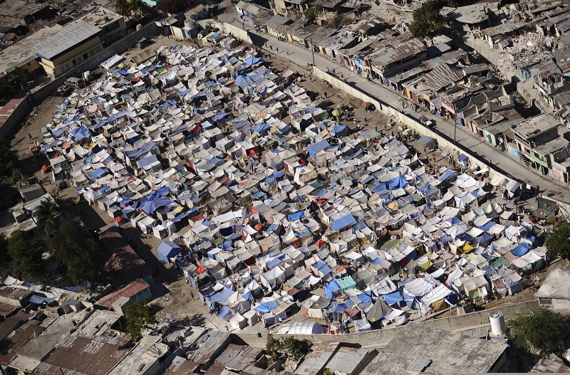 59. A Large Tent City, Packed With Makeshift Shelters, Is Home To Earthquake Survivors and Victims, January 28, 2010, Port-au-Prince, Republique d'Haiti (Repiblik d' Ayiti) - Republic of Haiti. Photo Credit: Mass Communication Specialist 2nd Class Kristopher Wilson, United States Navy; Defense Visual Information (DVI, http://www.DefenseImagery.mil, 100128-N-5345W-266) and United States Navy (USN, http://www.navy.mil), United States Department of Defense (DoD, http://www.DefenseLink.mil or http://www.dod.gov), Government of the United States of America (USA).
