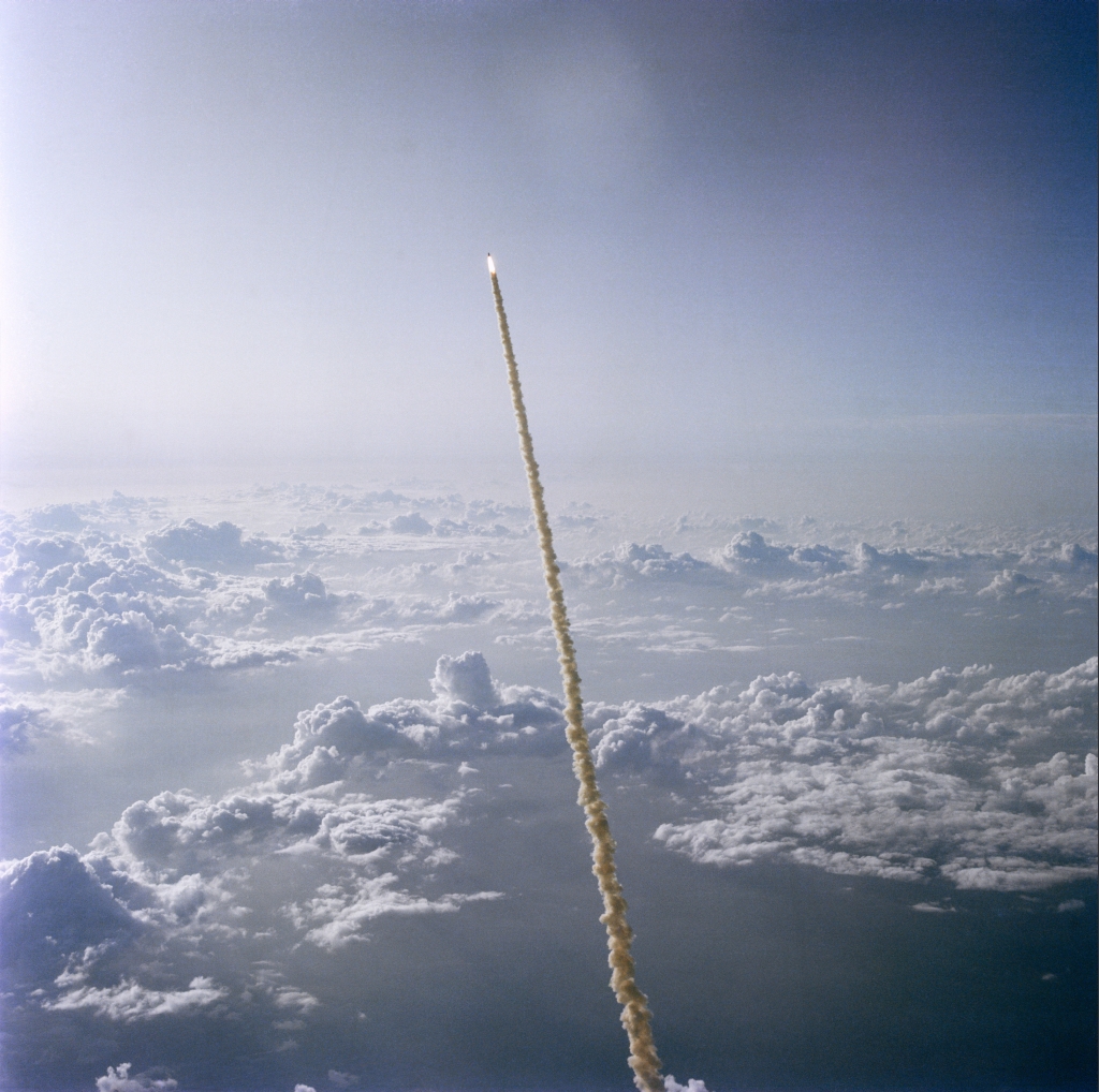 A Spectacular Aerial View of Space Shuttle Challenger (STS-7) -- High Above the Clouds and Florida's Atlantic Ocean Coastline -- Roaring Into Space on June 18, 1983, As Seen From NASA's Shuttle Training Aircraft (STA), State of Florida, USA. Photo Credit: Astronaut John W. Young, NASA; STS-7 Shuttle Mission Imagery (http://spaceflight.nasa.gov/gallery/images/shuttle/sts-7/ndxpage1.html): S83-35620 (http://spaceflight.nasa.gov/gallery/images/shuttle/sts-7/html/s83-35620.html), NASA Human Space Flight (http://spaceflight.nasa.gov), National Aeronautics and Space Administration (NASA, http://www.nasa.gov), Government of the United States of America.